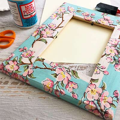 frame on table with decoupage materails